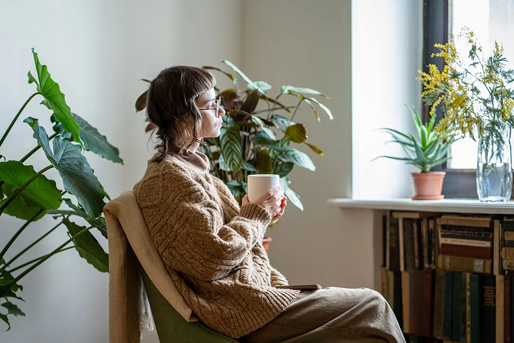 Pregnant woman relaxing at home after receiving housing and utility assistance while creating an adoption plan.