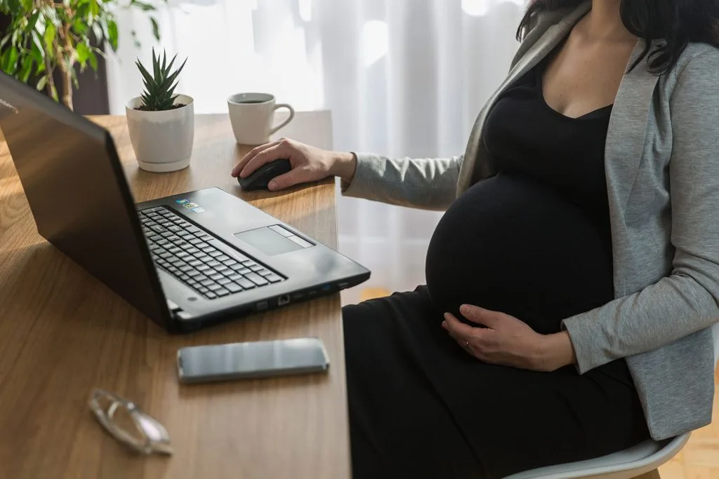 Pregnant woman meeting with a Heart to Heart adoption specialist to discuss adoption options and create an adoption plan.