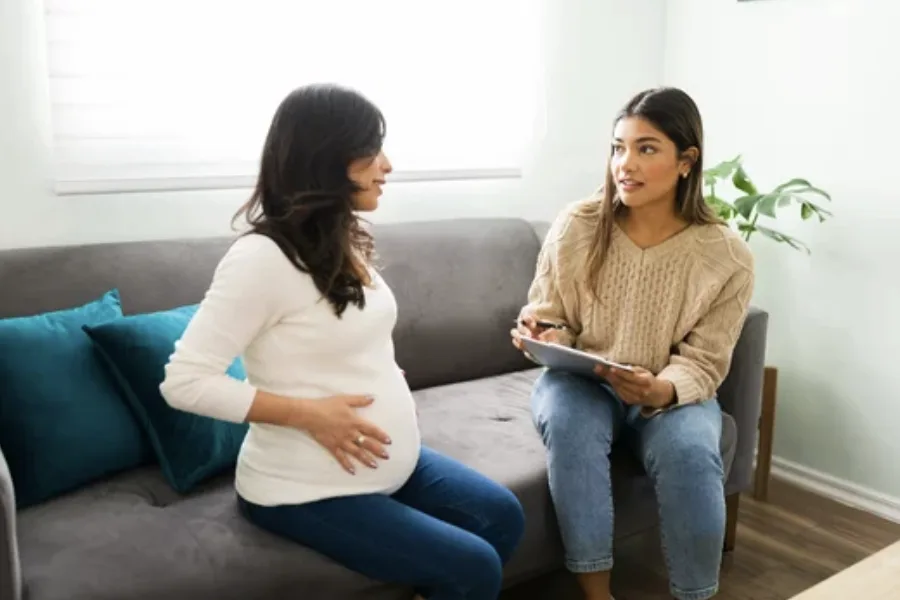 Birth mother reviewing adoption paperwork with support and no pressure
